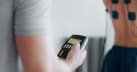 Physiotherapy, emg machine and monitor with hands in clinic for biofeedback, muscle or track...