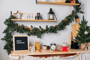 wooden kitchen with letterboard and calendar December 25, decorated with Christmas decorations. Beautiful and cozy kitchen at Christmas