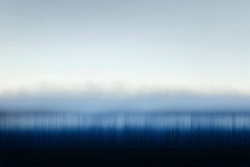Fototapeta premium Serene abstract landscape; subtle blue hues gradient, mimicking a misty horizon over a tranquil body of water. Ideal for calming, minimalist design projects.