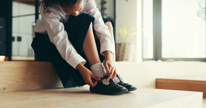 Hands, child and tie shoes for school as morning routine, getting ready in home or preparation for education. Feet, uniform and girl student with start to day for learning, dressing or footwear
