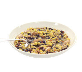 Pasta and bean soup with metal spoon in white bowl on transparent background