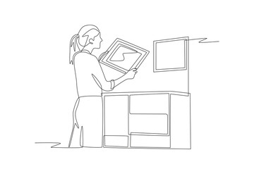 Woman adds display for decoration. DIY decorations concept one-line drawing