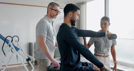 Physiotherapy, consulting and dumbbell with man in clinic for medical, muscle performance and track progress. Rehabilitation, healthcare and training with people for chiropractor, help and healing © Clement/peopleimages.com