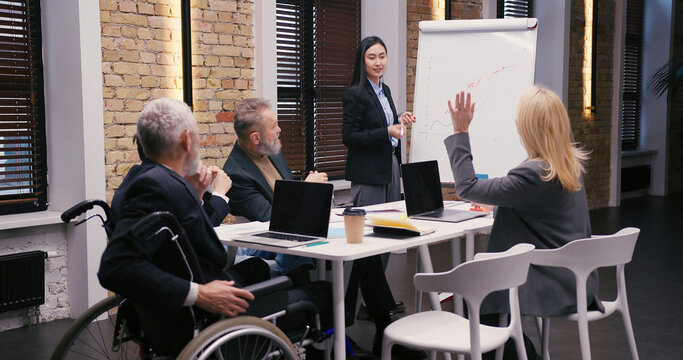 Young Asian businesswoman discusses statistical data
