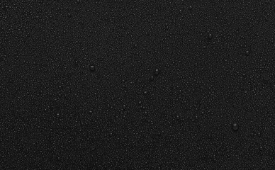 water drops on uniform black plastic background