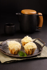 Ensaymada is Filipino Soft Bread, Covered with Butter and Sugar then Topped with Greated Cheese. 