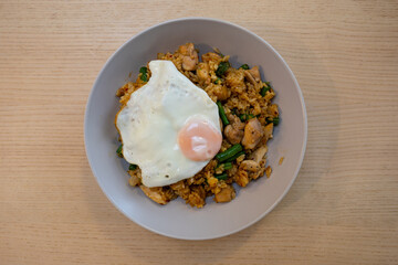 Chicken fried rice with egg on top.