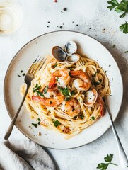 A delicious plate of pasta with shrimp and clams, garnished with parsley.