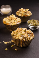 Pumpkin Muffins or Pumpkin Cupcakes Topping with Streusel and Pumpkin Seeds. 