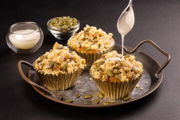 Pumpkin Muffins or Pumpkin Cupcakes Topping with Streusel and Pumpkin Seeds. 