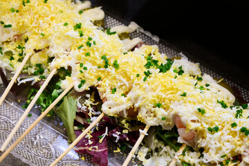 Boiled egg canapes with shrimp and mayonnaise served on a skewer
