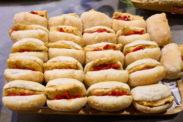 Delicious sandwich tray with breaded cod and red peppers
