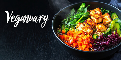 Colorful vegan noodle bowl with tofu and fresh vegetables during Veganuary celebration