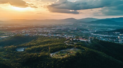 Obraz premium Aerial view of a city nestled in a valley at sunset. Concept of panoramic landscape, travel, and exploration.