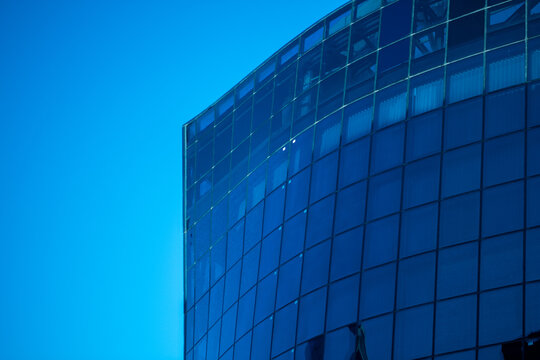 Modern curved glass building top detail, background for business corporate, building against blue sky reflection, 4k stock photo - Powered by Adobe