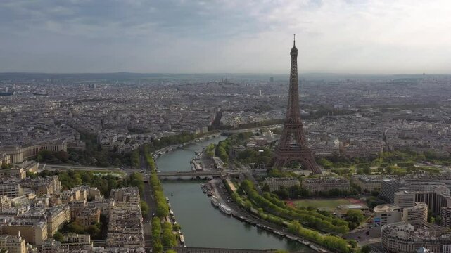PARIS, FRANCE - OCTOBER 3, 2024: Beautiful aerial view of the Eiffel Tower and Seine River with city landscape under cloudy sky