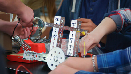 Close Up Of High School College Or University Students Building Robotic Vehicle In Science Lesson © Monkey Business