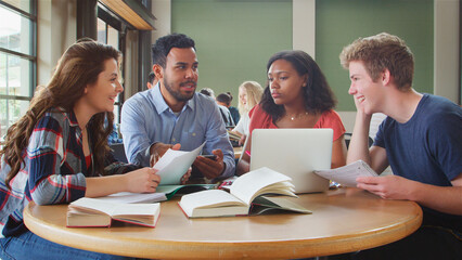 Male And Female Teachers With Students In High School College Or University Classroom Lesson