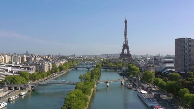 PARIS, FRANCE - OCTOBER 3, 2024: Captivating view of the Eiffel Tower overlooking the Seine River with boats and lush trees in autumn