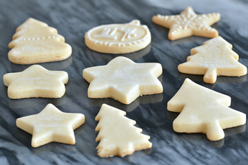 A plate of cookies with a star, tree, and snowflake on it