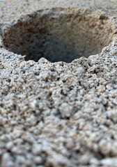 hole in a concrete block with holes and cracks