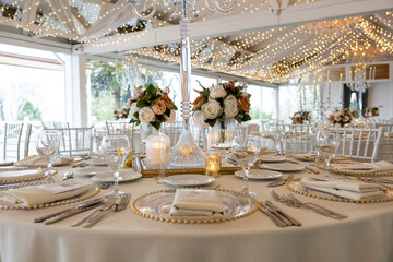 Romantic wedding table setting with fairy lights and crystal candlesticks
