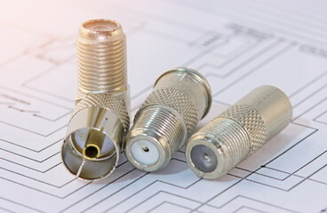 Metal F-connectors for connecting coaxial cable. Close-up. Soft focus.