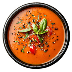 Top view of creamy tomato soup on a dark stone bowl isolated on a white transparent background