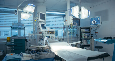 Empty Operating Room is Illuminated by Advanced Surgical Lights, Showcasing Modern Medical Equipment and Sterile Preparation for Upcoming Surgical Procedures. Photo Without People in Modern Clinic