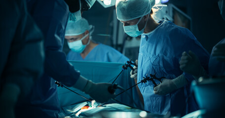 Wearing Sterile Gear in Operating Room, Multicultural Male and Female Surgical Team Collaborates...