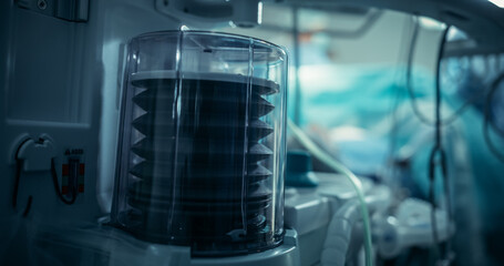 Ventilator Pump Operates Steadily in a Dimly Lit Intensive Care Room, Highlighting Essential Medical Technology in Patient Care. Scene Emphasizes Reliability in a Critical Healthcare Setting