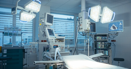 Photo Without Staff in Modern Clinic. Empty Operating Room with Advanced Surgical Lights. Medical Equipment, Computer Screens and Sterile Preparation for Upcoming Surgical Procedure