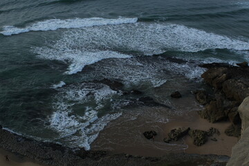 Serene Waves Crashing Upon the Rocky Shore