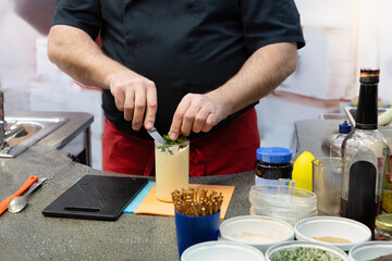 Chef preparing raw sauce in saloon kitchen.