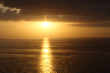 The horizon that separates the calm ocean from the bright sky is faintly visible.
