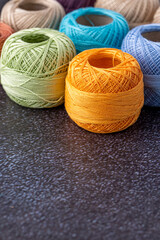 Multicolor yarn for knitting, knitting needles and scissors. Home storage concept and hobby.Raffia is an organic, ecological, wood fiber that is easy to crochet.