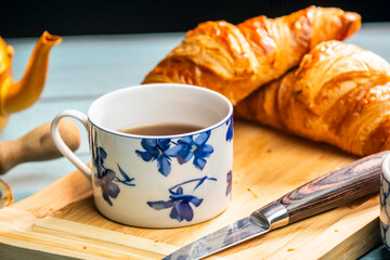a jug on the side, some berries, butter and a croissant