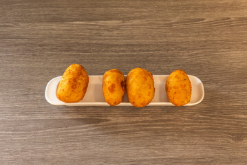 by being small portions of dough that usually contain a filling, which can be meat, fish, seafood,...