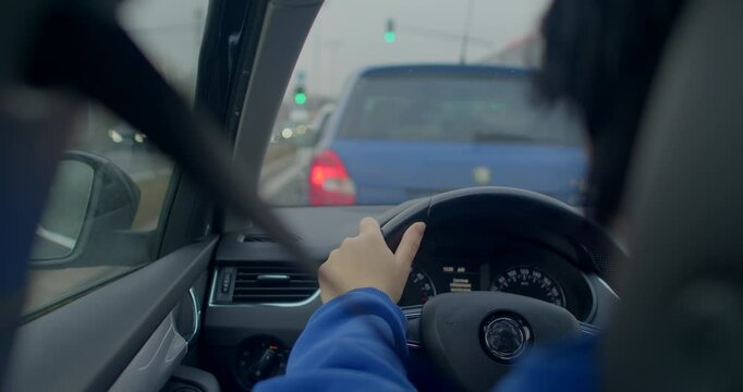 A drivers view in a traffic jam, with blurred vehicles behind, highlighting the congestion