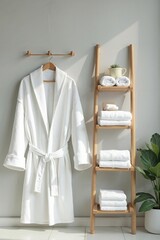 Minimalist bathroom with white robe and wooden ladder, spa-like