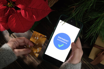Payment for Christmas online shopping using bank card. Money transfer online.