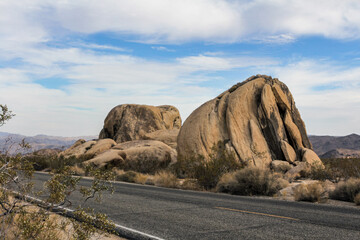 A vast desert landscape in Joshua Tree National Park, featuring rugged rocks and sparse vegetation