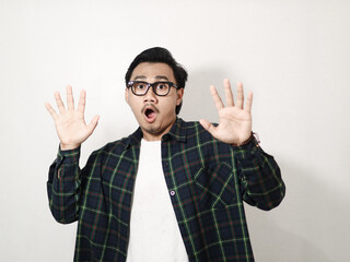 Adult Asian man looking camera with shocked expression isolated on white background