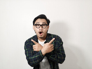 Adult Asian man showing shocked expression with both hands pointing to the left and right side