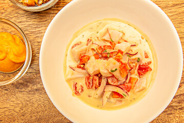 Ceviche is a small, traditional Latin American appetizer consisting of pieces of raw seafood or fish with an acidic marinade (in citrus juice or vinegar) that 