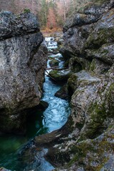 A stream and waterfall in the Walchenklamm gorge in the Bavarian Forest in late autumn. Rocks...