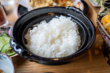 Ginzan onsen, Yamagata, Japan, White rice served in a black bowl on a wooden table.