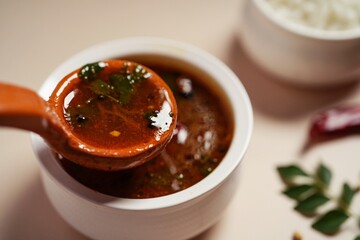 Tomato rasam served with rice, selective focus