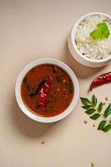 Tomato rasam served with rice, selective focus