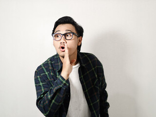 Adult Asian man doing whisper gesture isolated on white background